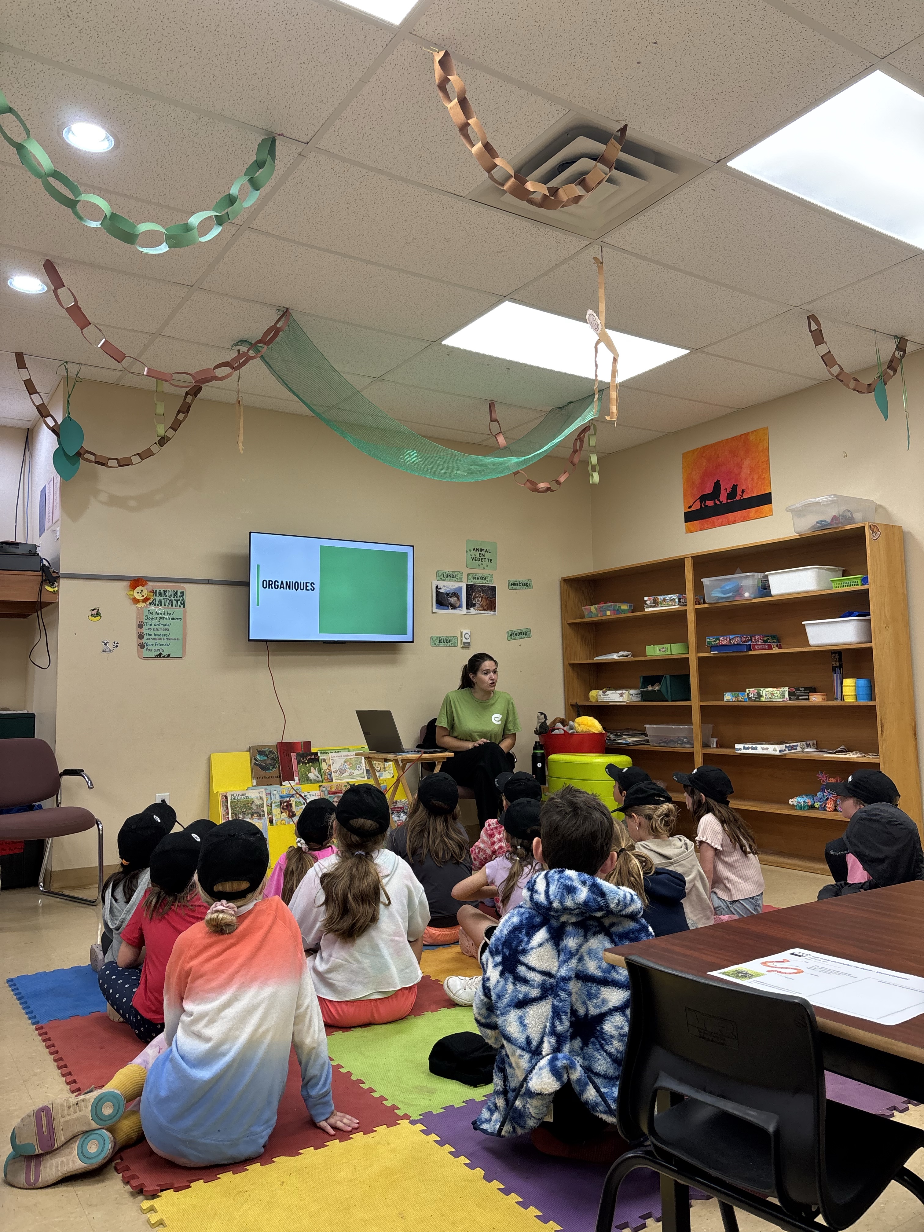 One of the educators doing a presentation in front of kids in a classroom