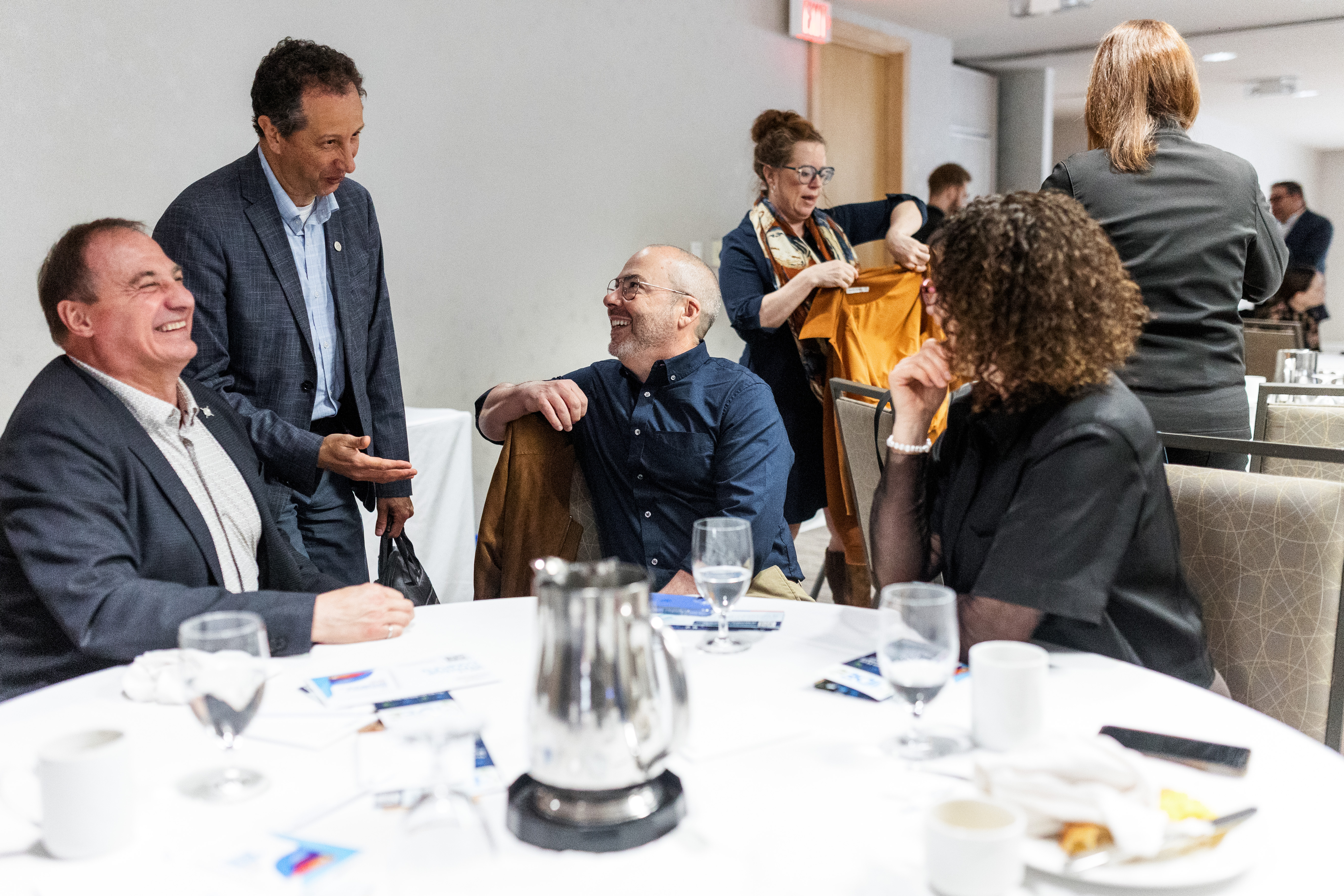 People around a table having a lively conversation